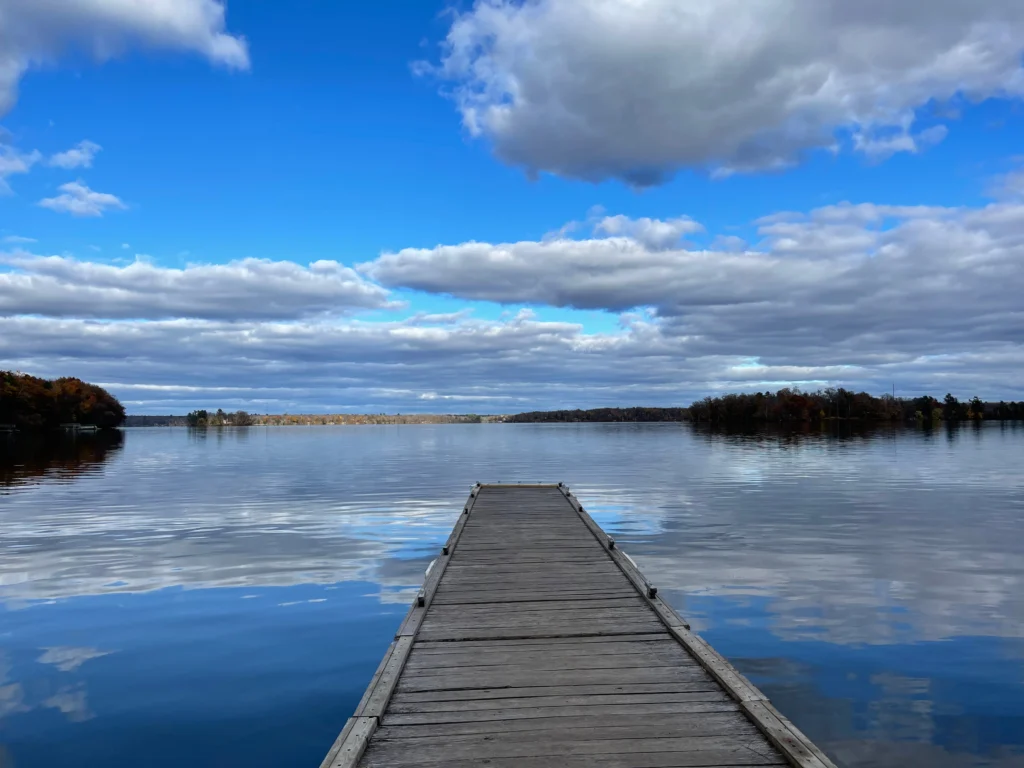 Peaceful dock on Birchwood WI lake under a bright blue sky