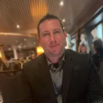 Person seated in the Holland America Line main dining room on a cruise ship