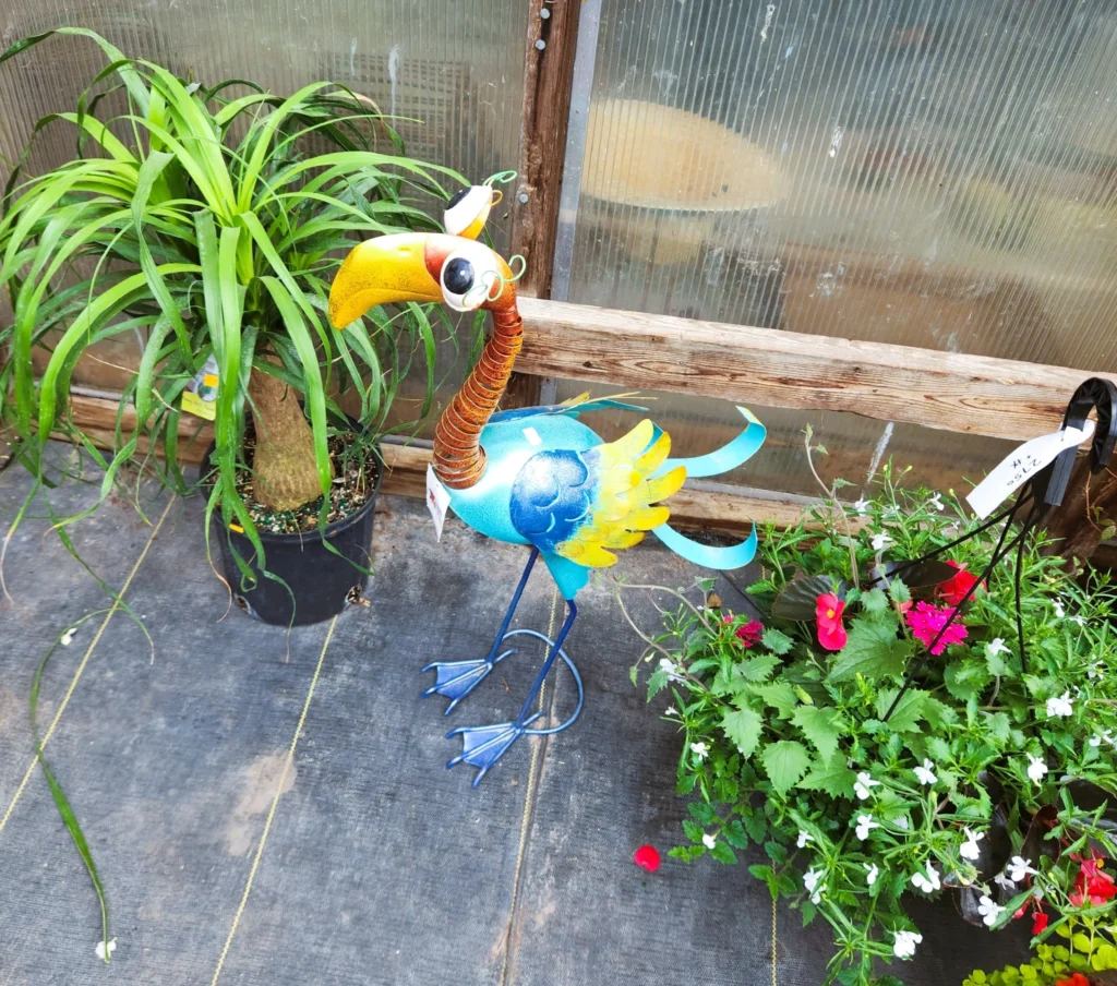 Colorful metal flamingo lawn ornament for sale at an Amish greenhouse near St. Charles MN