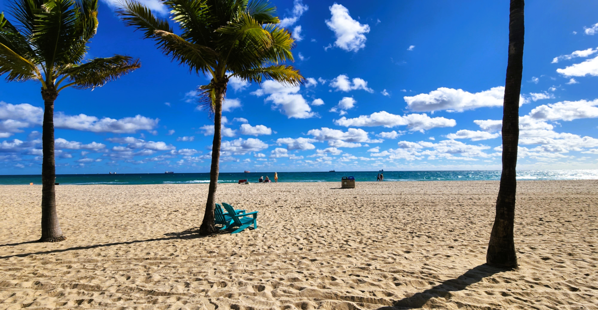 Sunny day at Fort Lauderdale Beach with palm trees and ocean views – popular Florida best cruise ports