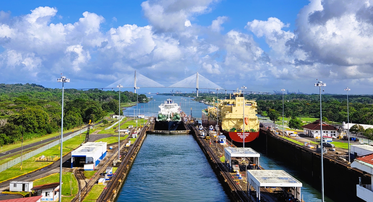 A cruise ship entering the Panama Canal under blue skies