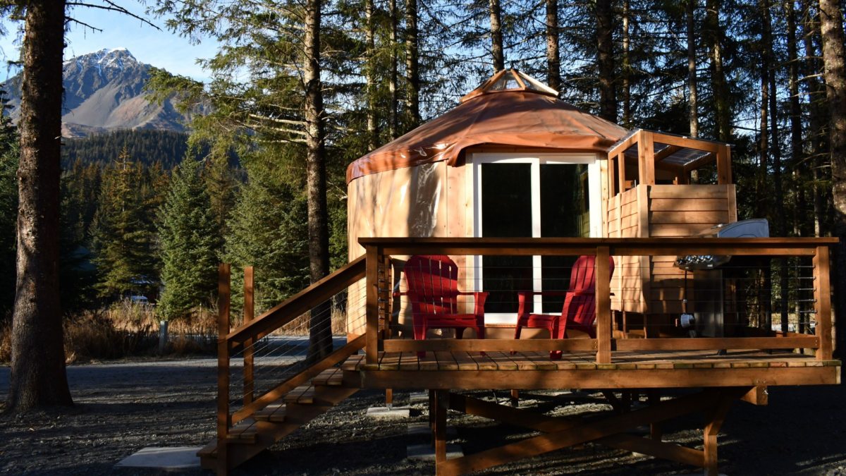 Creekside yurt rental in Seward, Alaska, with mountain views and a salmon-run creek nearby — a cozy nature getaway perfect for couples or small families.