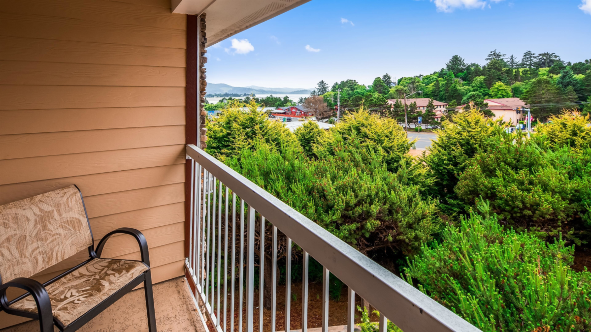 Balcony view from Best Western Plus Landmark Inn in Lincoln City Oregon surrounded by trees and coastal hills