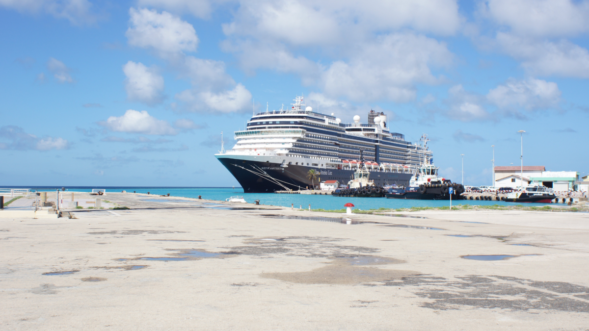 Aruba travel guide. Large cruise ship docked in Oranjestad, Aruba on a sunny day.
