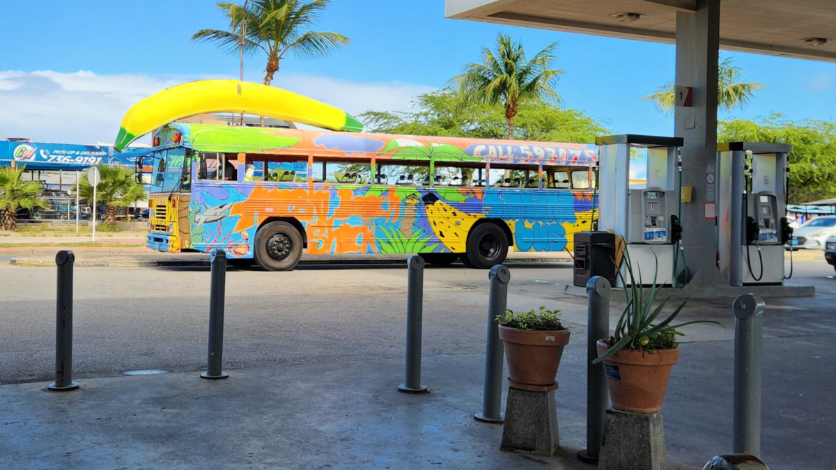Colorful Aruba party bus near Oranjestad cruise port. Aruba cruise beach day