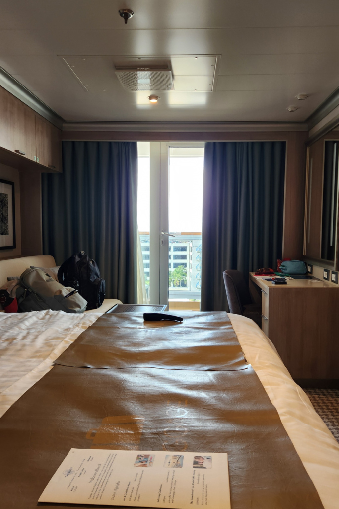 Holland America Rotterdam Verandah Cabin Interior - Dohrn Travels Holland America Rotterdam Verandah cabin interior with bed and balcony doors