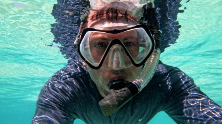Snorkeling at Grote Knip Beach in Curaçao with clear turquoise water and rocky reef