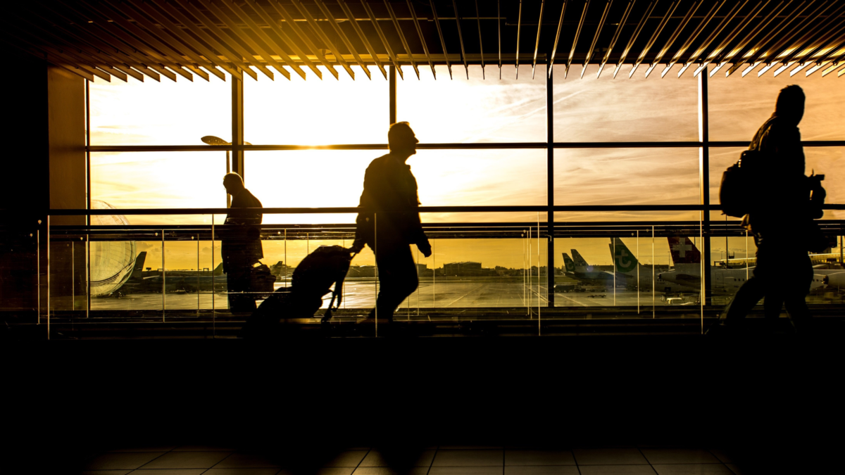 Travelers walking through Fort Lauderdale Airport after arriving for a cruise from Port Everglades