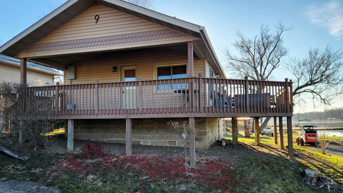 Cabin exterior with porch and hot tub Eagle Roost Resort Cassville WI. Cassville WI cabin rental