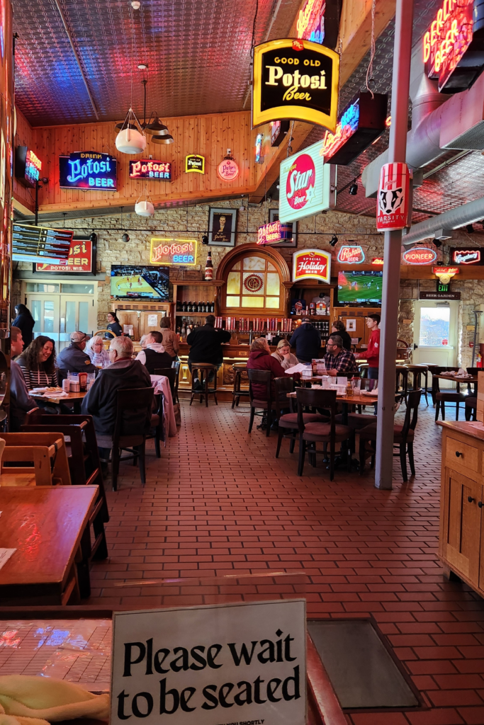 Inside Potosi Brewery brewpub with tables, bar, and vintage beer signs