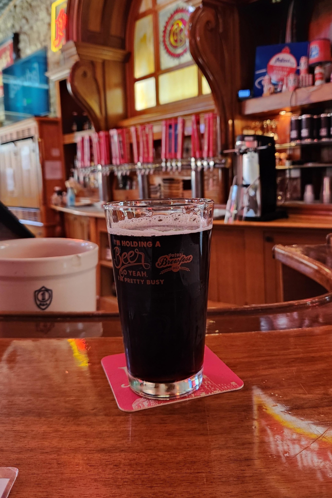 Glass of Potosi root beer on bar inside Potosi Brewery brewpub
