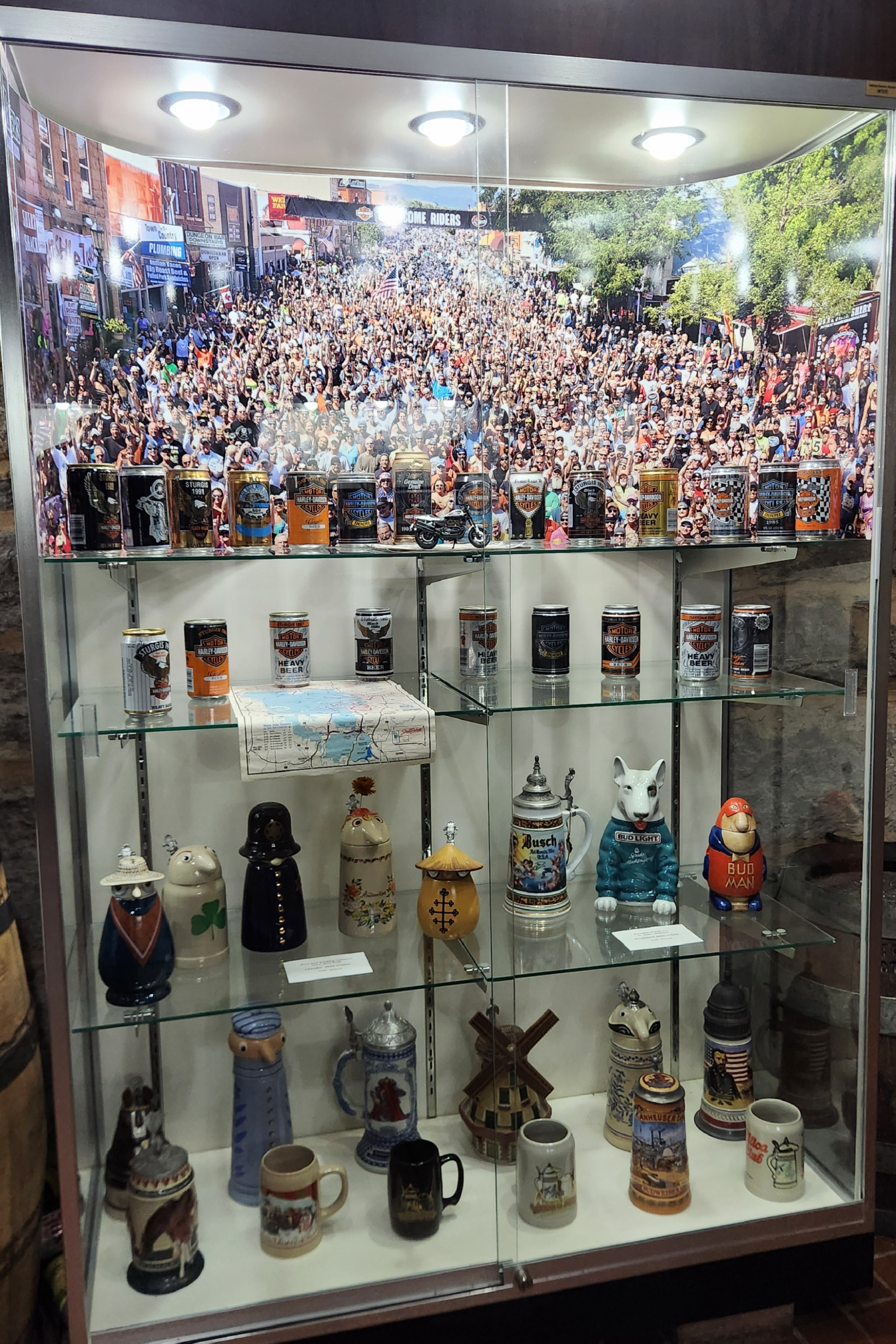 Beer memorabilia display case inside Potosi Brewery museum with cans and collectibles