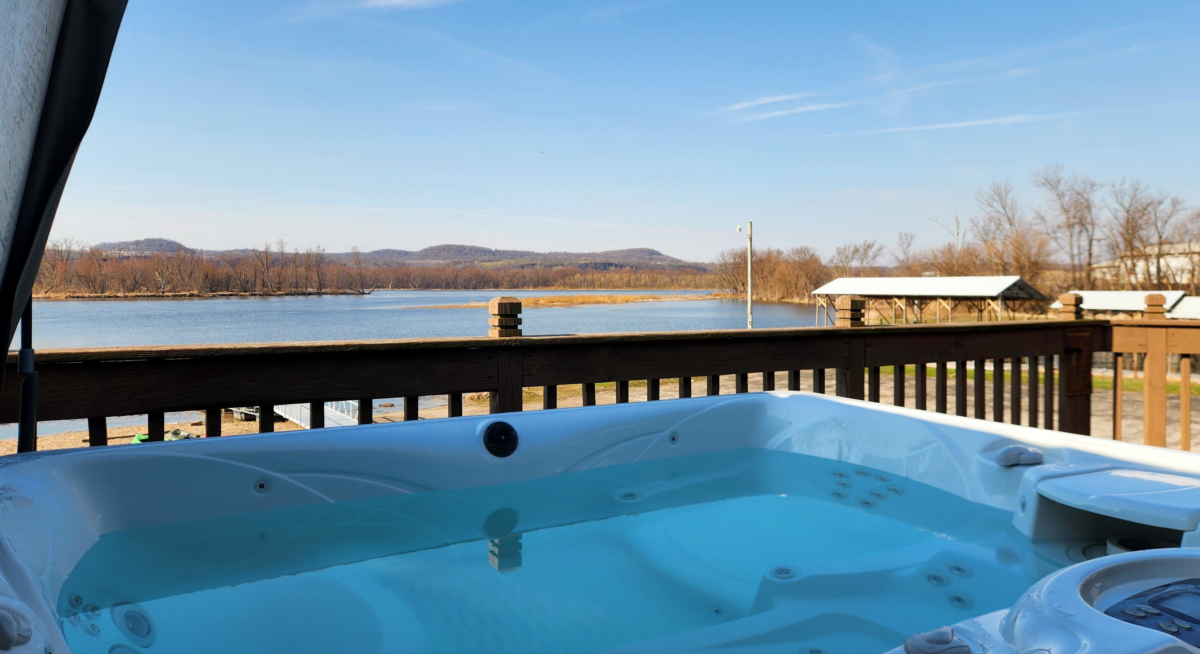 Hot tub overlooking Mississippi River from cabin deck Eagle Roost Resort. cabin with hot tub river views Wisconsin