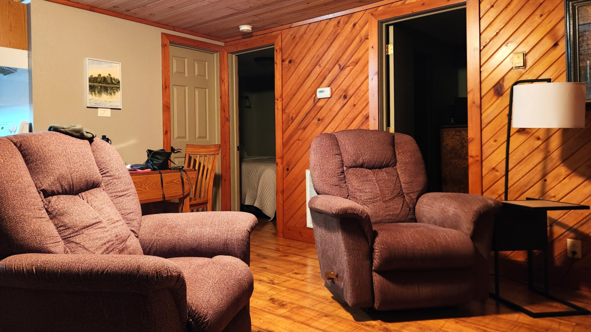 Living room inside Eagle Roost Resort cabin with chairs and wood interior