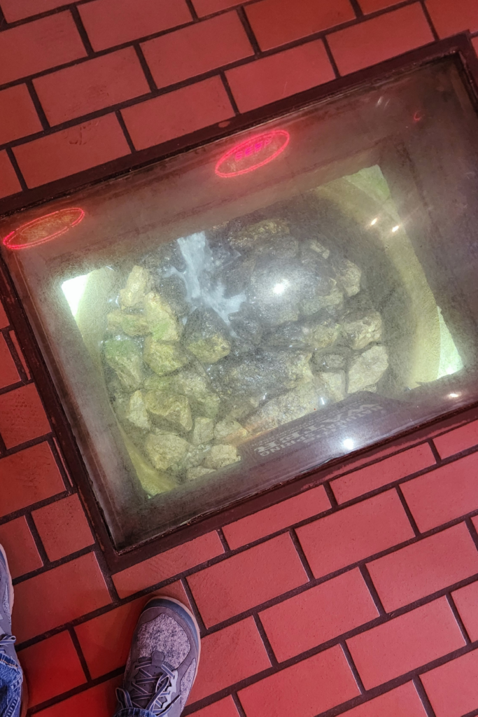 Natural spring visible under glass floor inside Potosi Brewery