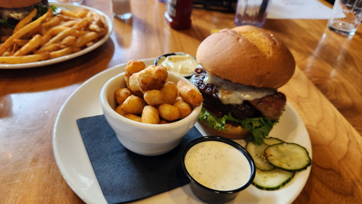 Burger with cheese curds and dipping sauce at Toppling Goliath Brewing Co