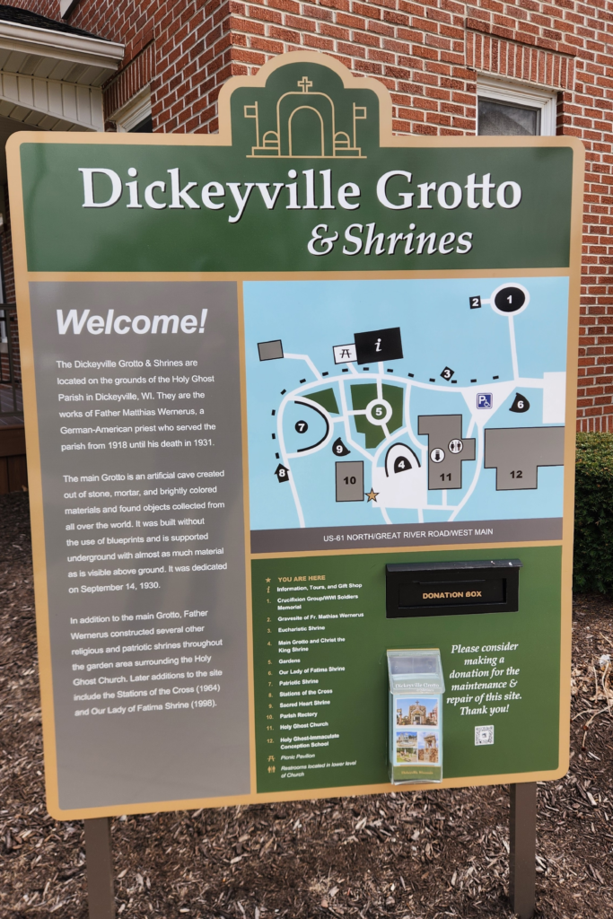 Welcome sign and map for Dickeyville Grotto & Shrines in Wisconsin. grotto hours and admission