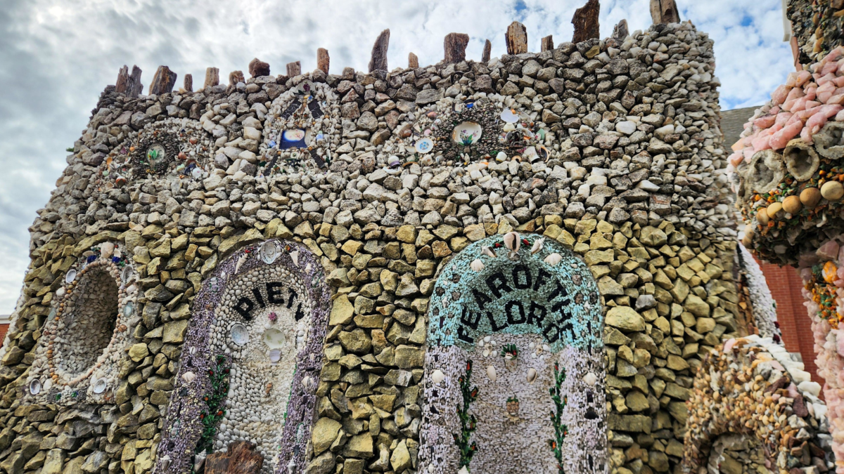 Decorative shell mosaic wall with arches and religious artwork at Dickeyville Grotto