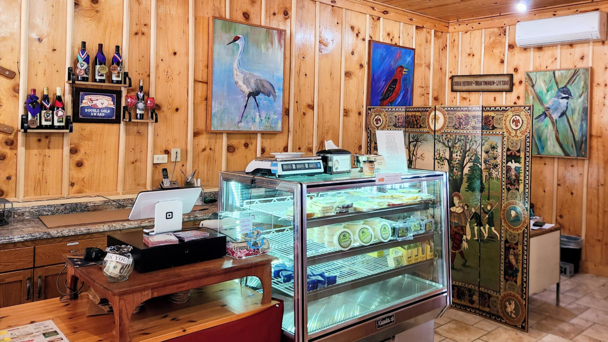 artwork and cheese display inside Whispering Bluffs Winery tasting room
