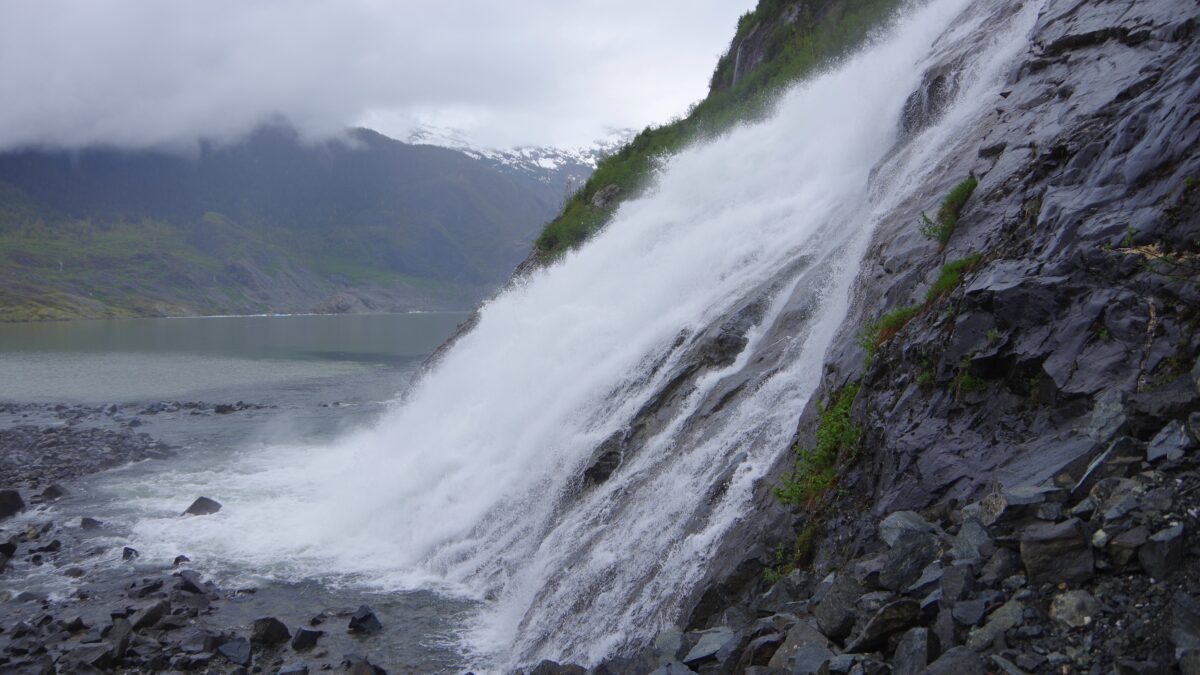 Nugget Falls cascading beside Mendenhall Glacier Lake in Juneau, Alaska