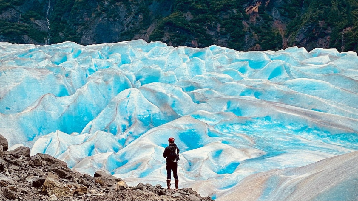 Hiker exploring glacier ice during a Mendenhall Glacier adventure tour