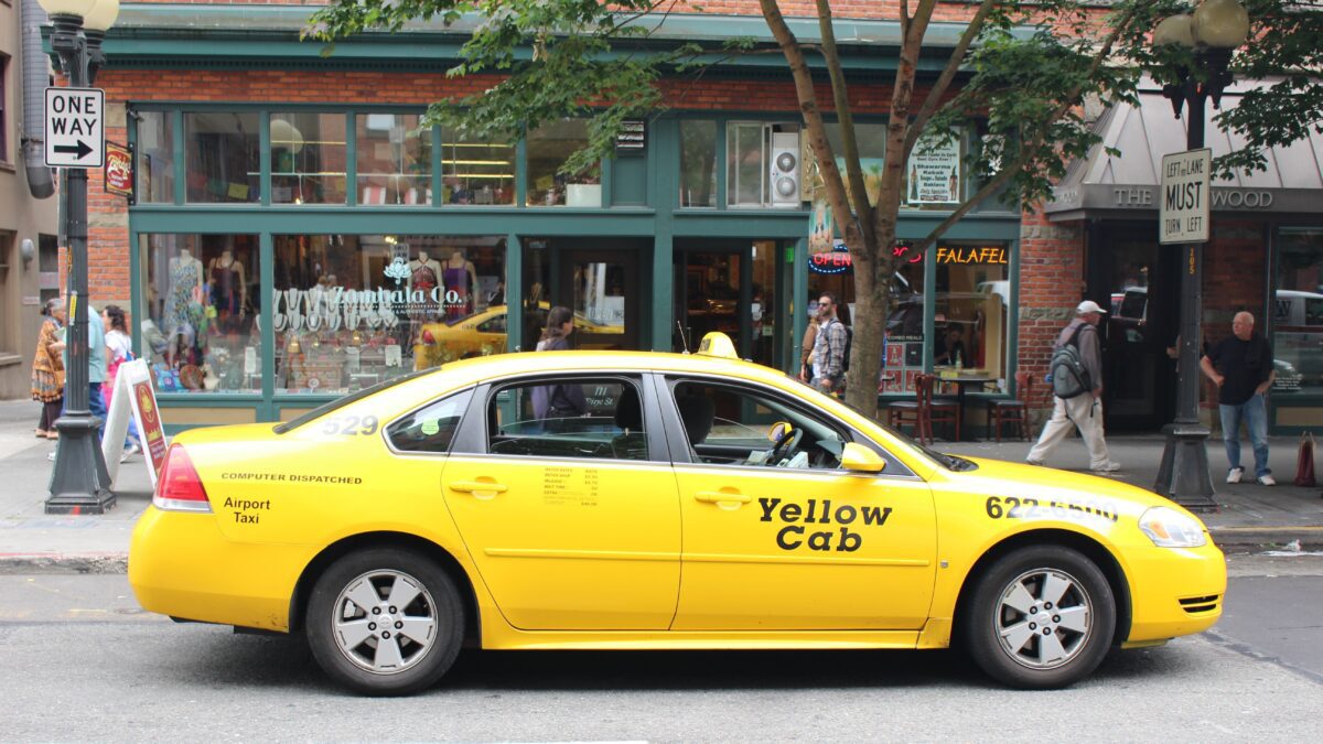 Yellow taxi waiting in downtown Seattle for airport and cruise port transportation.