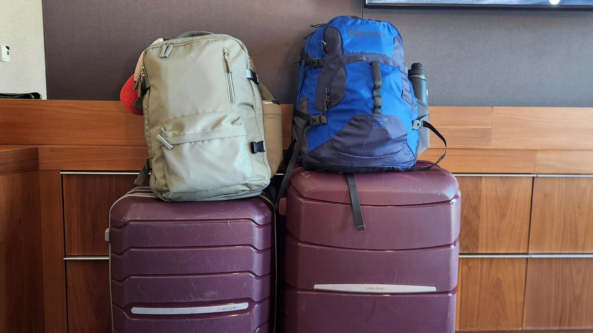 Backpacks and Luggage for an Alaska Cruise | Dohrn Travels Two backpacks sitting on top of suitcases while packing for an Alaska cruise.