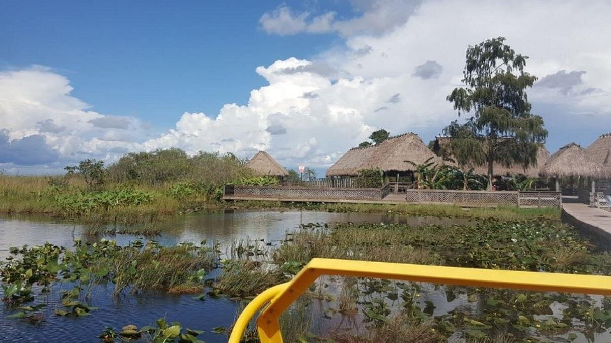 Thatched-roof village beside the wetlands on an Everglades tour
