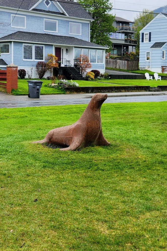 Sea lion sculpture on the lawn at Crescent Harbor Park in Sitka, Alaska.