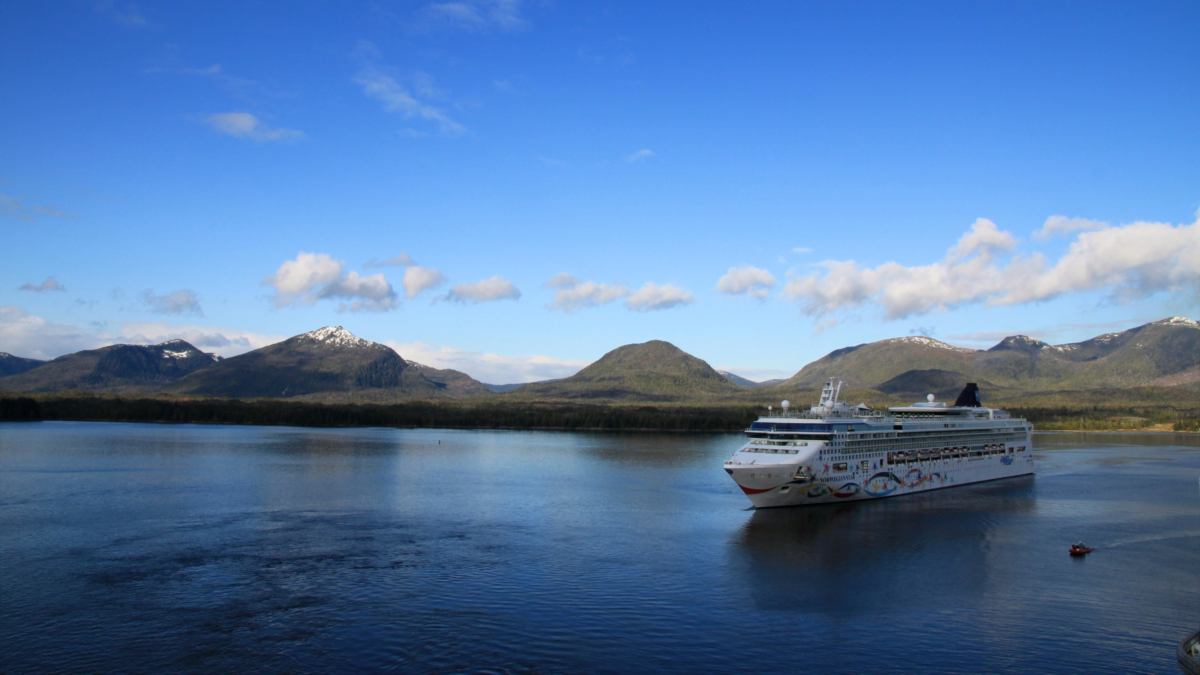 Cruise Ship Arriving in Ketchikan Alaska | Dohrn Travels Alaska cruise ship sailing through calm water surrounded by mountains near Ketchikan.