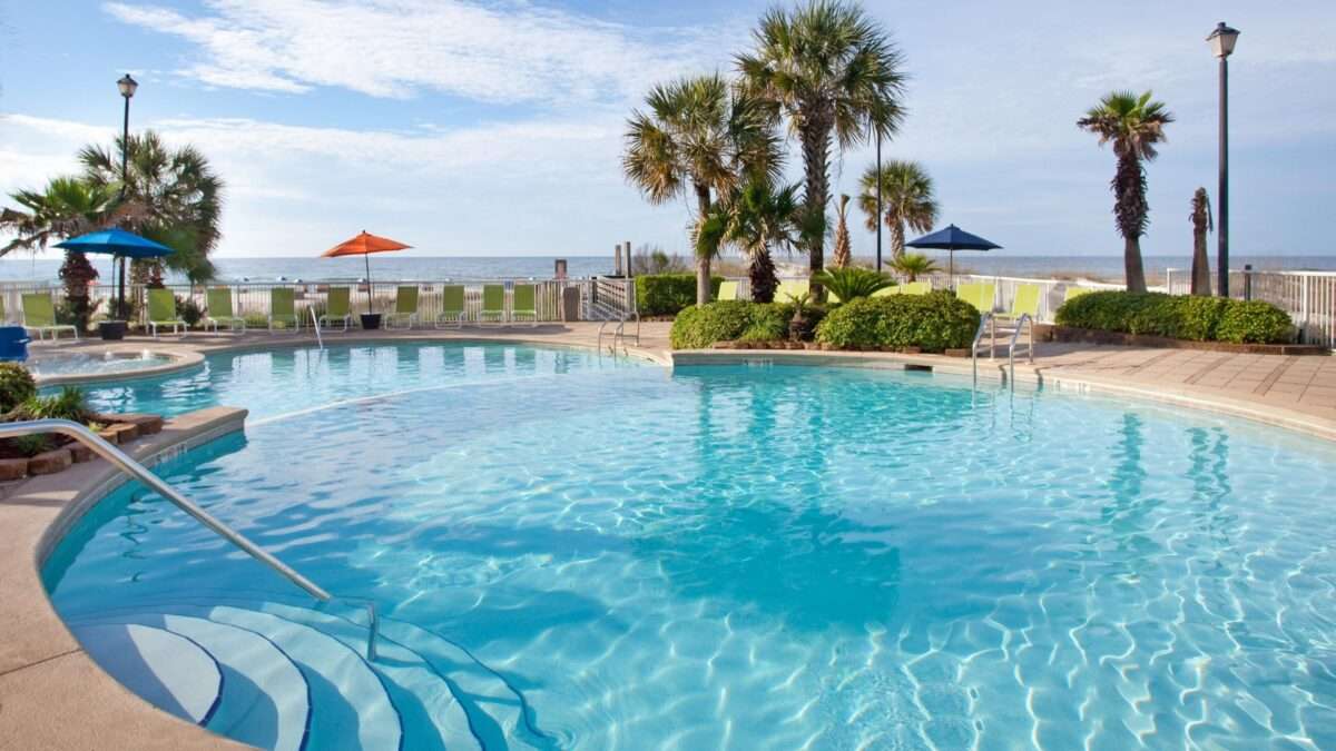 Outdoor hotel pool overlooking the beach at Holiday Inn Express Orange Beach. ResortPass Review