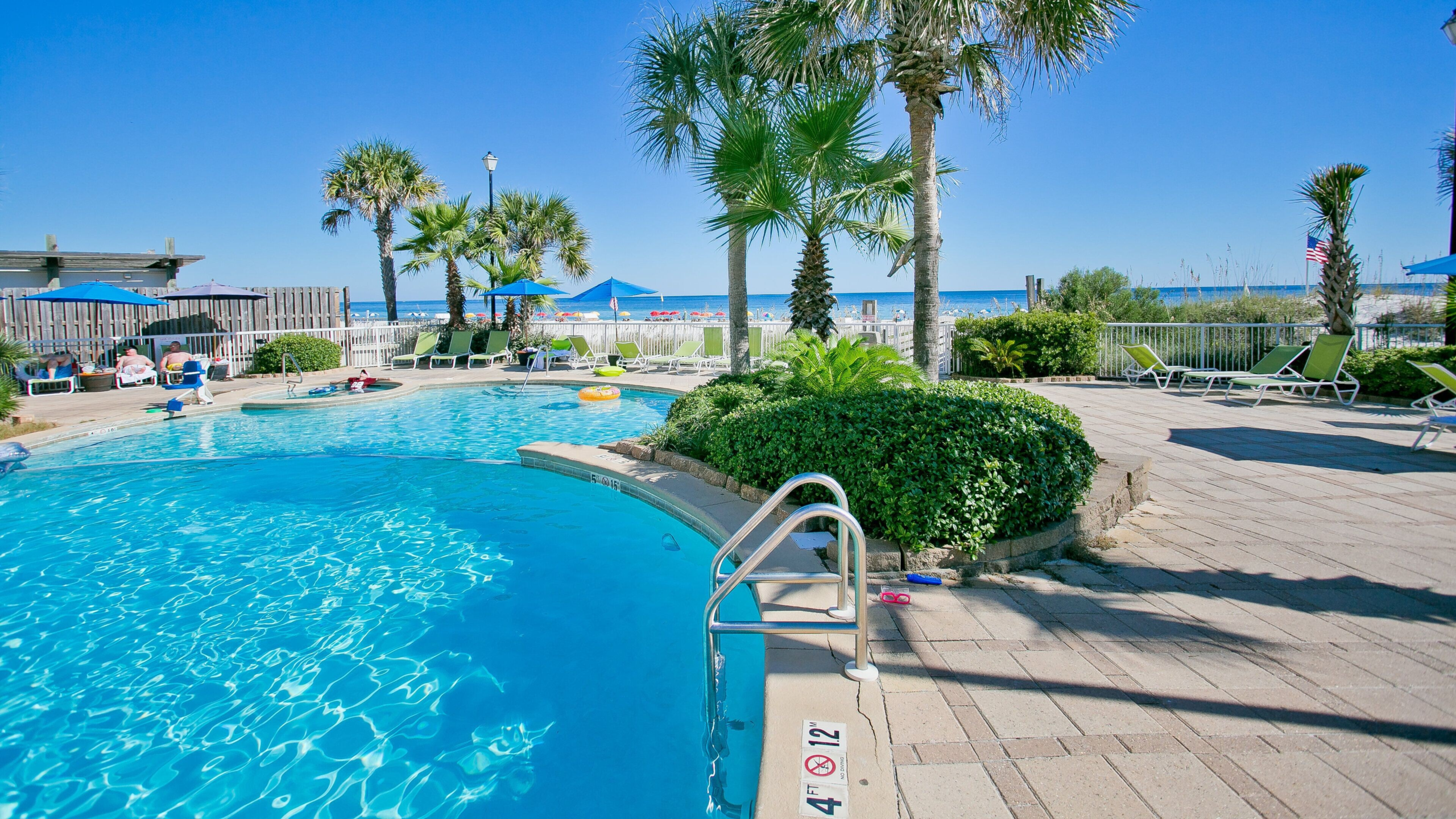 Outdoor pool with palm trees and Gulf views at Holiday Inn Express Orange Beach