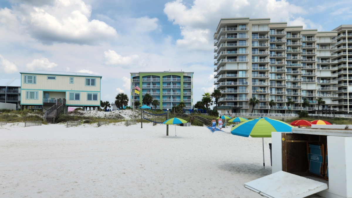 Beachfront hotels and colorful umbrellas along the sand in Orange Beach, Alabama