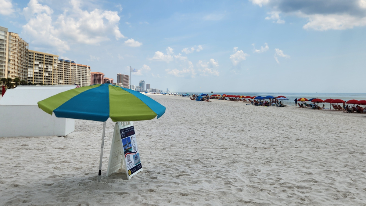 White-sand beach and colorful umbrellas along the Gulf in Orange Beach, Alabama