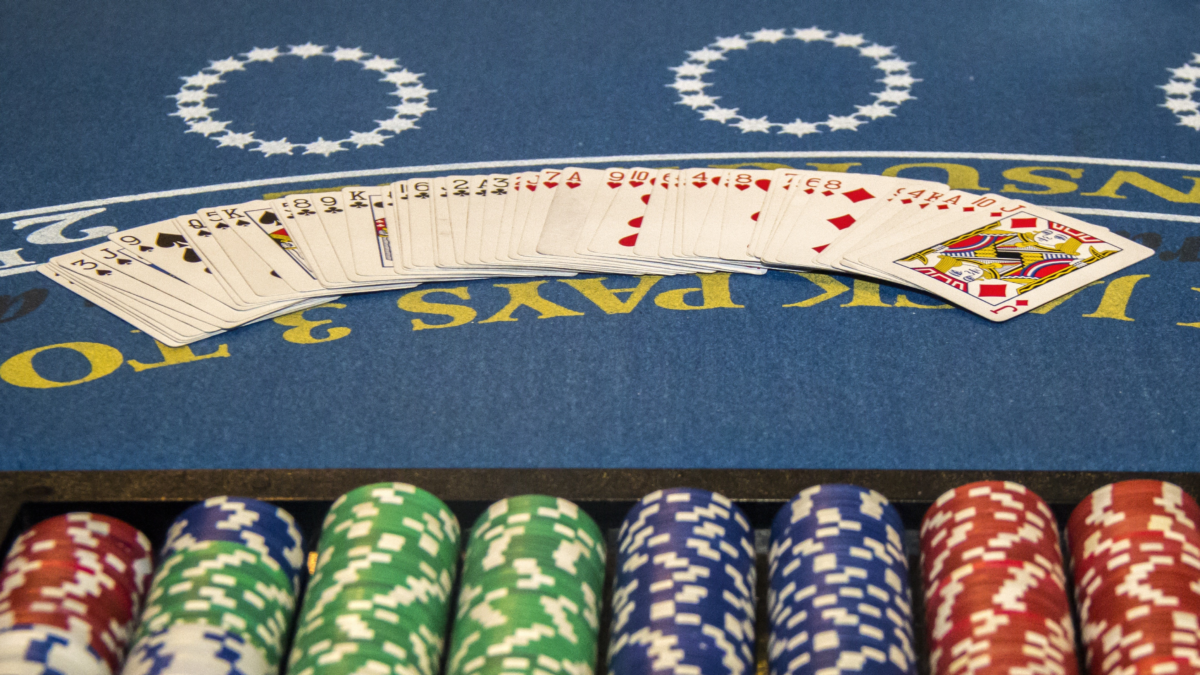 Blackjack table with playing cards and casino chips on a cruise ship