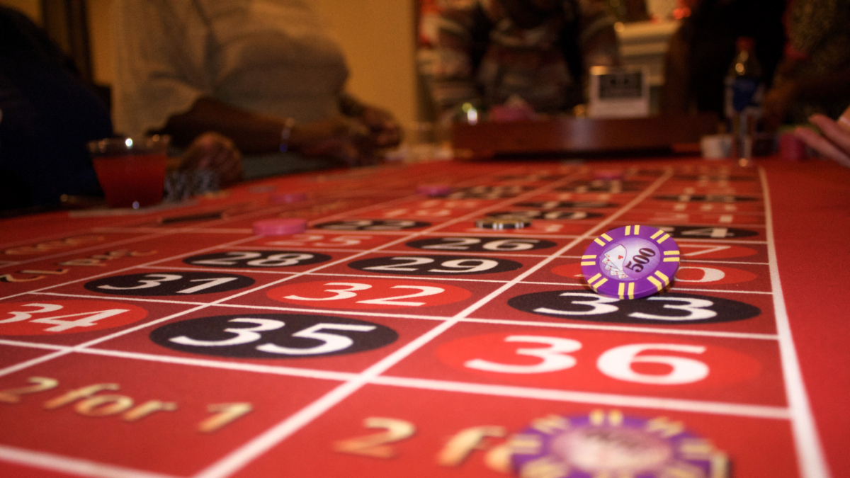 Roulette table with casino chips and players during a cruise ship casino game